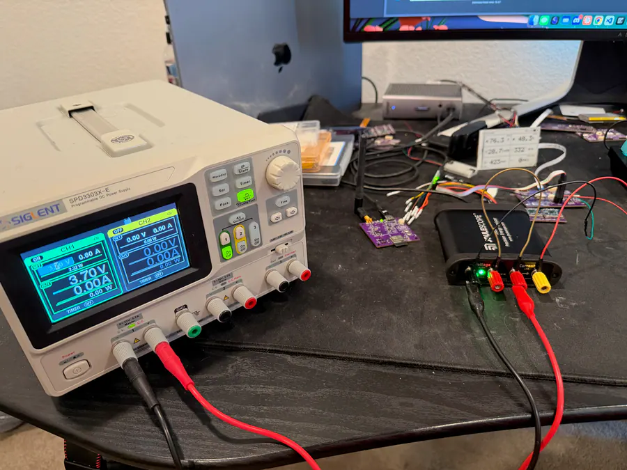 Siglent bench power supply set to LiPo-like voltage with EnviroIQ hardware, e-ink display, and JS220 visible on the bench.